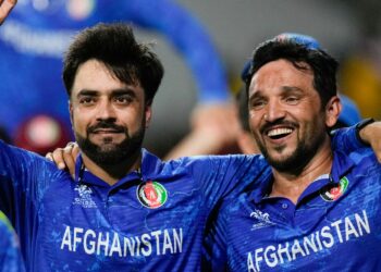 Afghanistan's captain Rashid Khan, left, and teammate Gulbadin Naib celebrate after defeating Bangladesh by eight runs in their men's T20 World Cup cricket match at Arnos Vale Ground, Kingstown, Saint Vincent and the Grenadines, Monday, June 24, 2024. (AP Photo/Ricardo Mazalan)
