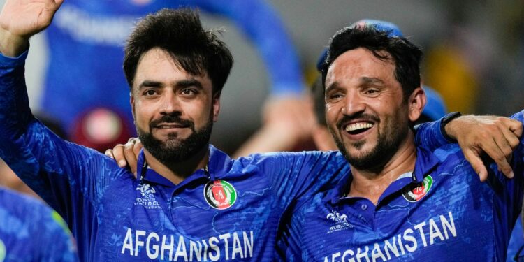 Afghanistan's captain Rashid Khan, left, and teammate Gulbadin Naib celebrate after defeating Bangladesh by eight runs in their men's T20 World Cup cricket match at Arnos Vale Ground, Kingstown, Saint Vincent and the Grenadines, Monday, June 24, 2024. (AP Photo/Ricardo Mazalan)