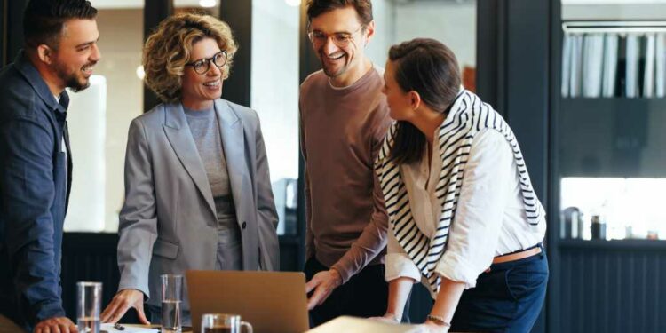 Group of business people having a meeting in a tech company. Creative business professionals planning a project in an office. Teamwork and collaboration in a modern workplace.