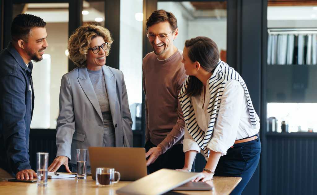 Group of business people having a meeting in a tech company. Creative business professionals planning a project in an office. Teamwork and collaboration in a modern workplace.