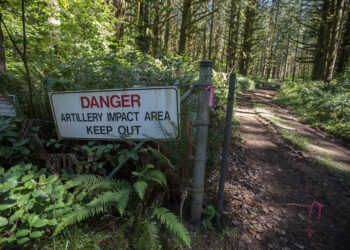 A sign and a barbed wire fence keeps visitors out of the artillery impact area at Camp Bonneville. A recently released audit by the state found the Department of Ecology has failed to perform required reviews of cleanup efforts at the county-owned property.