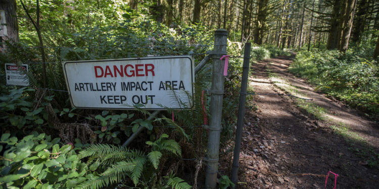 A sign and a barbed wire fence keeps visitors out of the artillery impact area at Camp Bonneville. A recently released audit by the state found the Department of Ecology has failed to perform required reviews of cleanup efforts at the county-owned property.