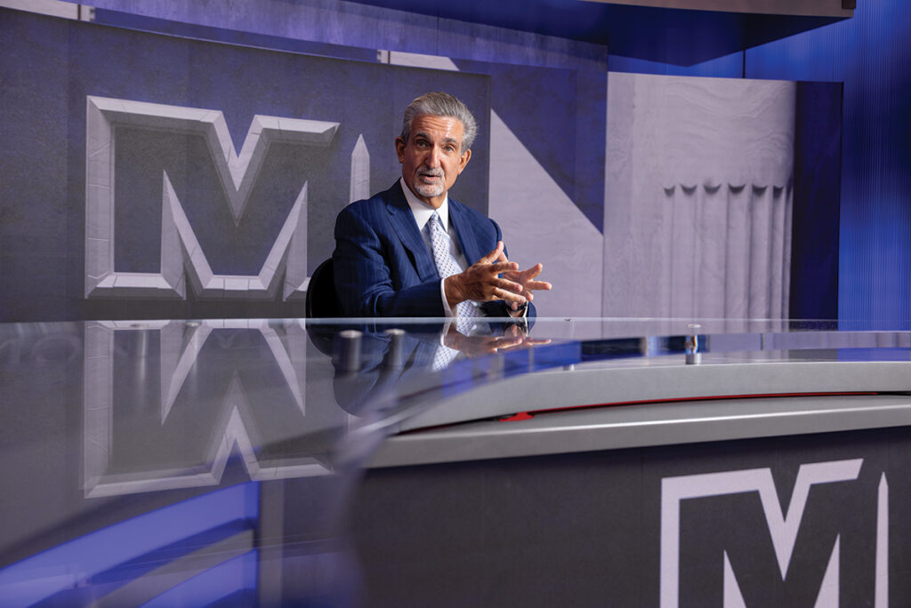 Ted Leonsis talking at a desk