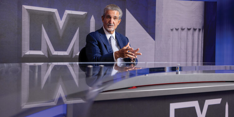 Ted Leonsis talking at a desk